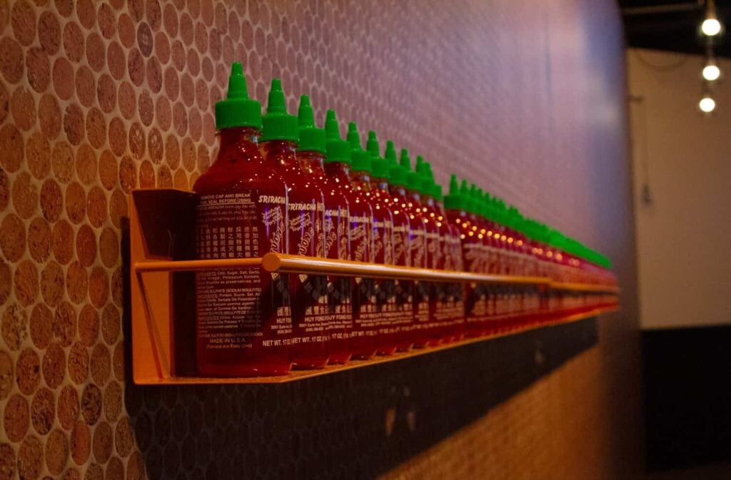 A red train is chugging along indoors.
