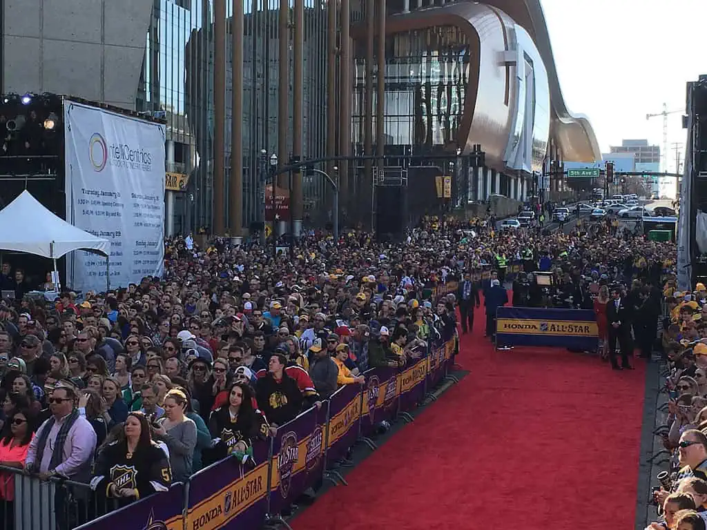 A large crowd gathers in the street.